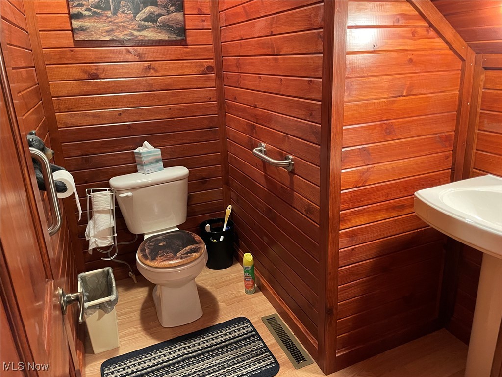 74068 Lake Ridge Road Piedmont, OH 43983 - Photo 25 of 45 Bathroom with wood walls and toilet