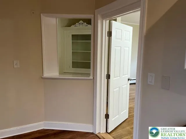 a kitchen with a sink a refrigerator and white cabinets