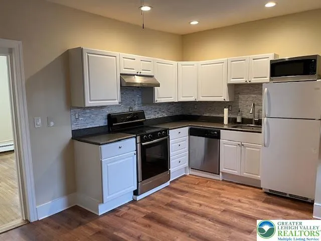 a kitchen with a stove and a sink