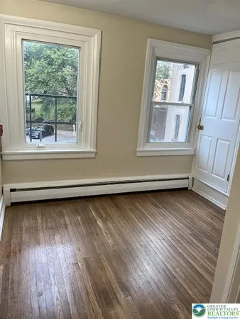 a view of room with window and hardwood floor