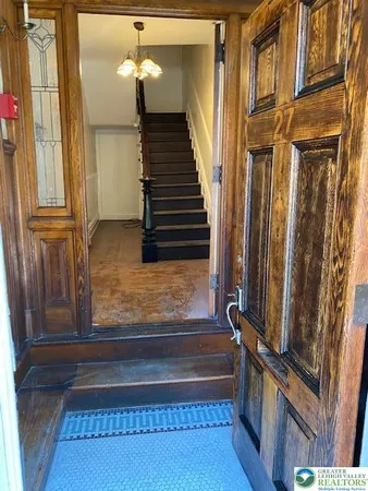 a view of a room with wooden floor and a window