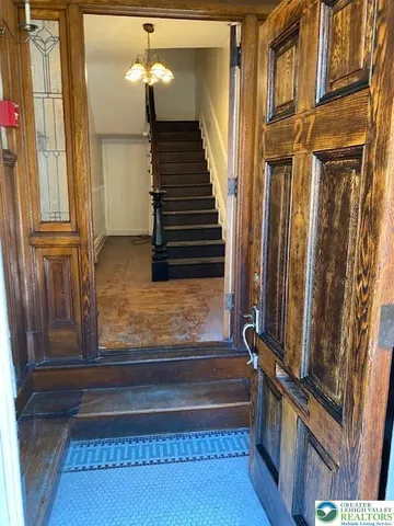 a view of a room with wooden floor and a window