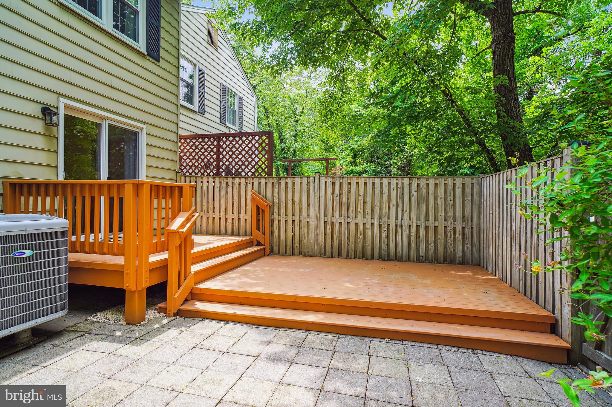 1049 Windrush Lane, Unit 2 Sandy Spring, MD 20860 - Photo 17 of 59 a view of backyard with deck and a garden