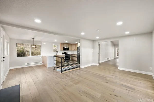 a view of kitchen with stainless steel appliances refrigerator microwave and stove