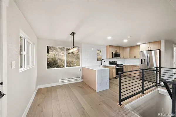 a kitchen with white cabinets and white appliances