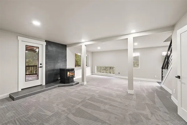 a view of an empty room with a fireplace and a window