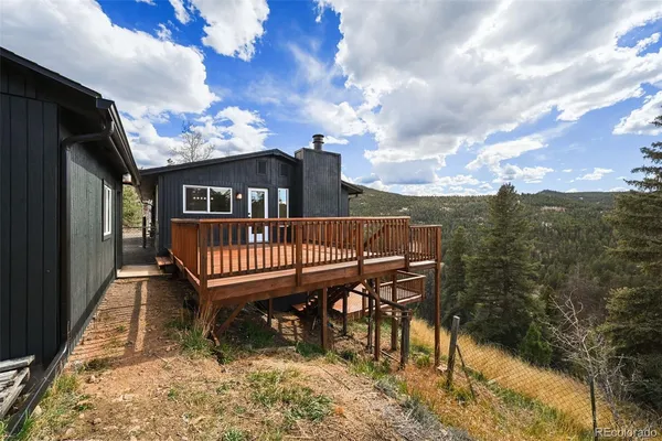 a view of a roof deck with chair and wooden floor