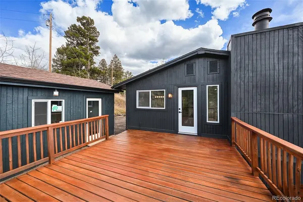 a view of backyard with deck and wooden floor