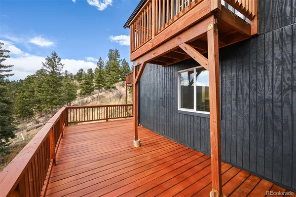 a balcony with wooden floor and stairs