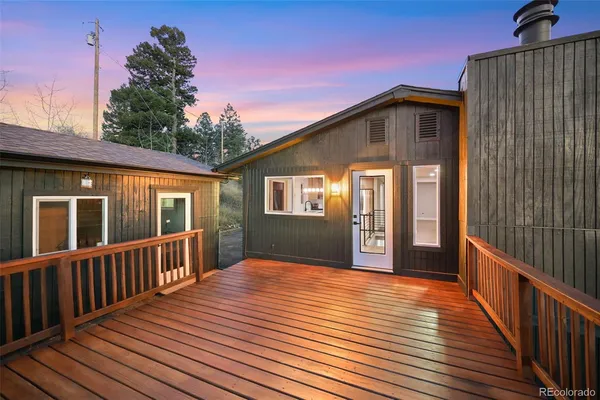 a view of backyard with deck and wooden floor