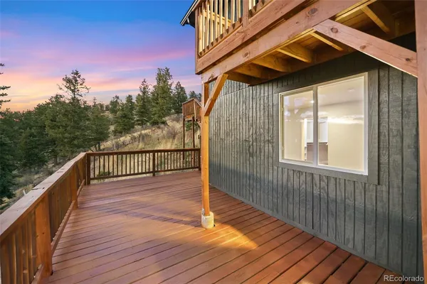 a view of balcony with wooden floor and fence