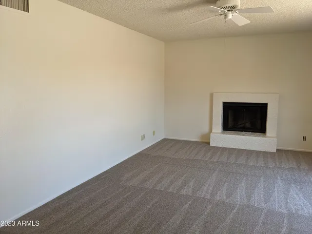 a view of an empty room with a fireplace