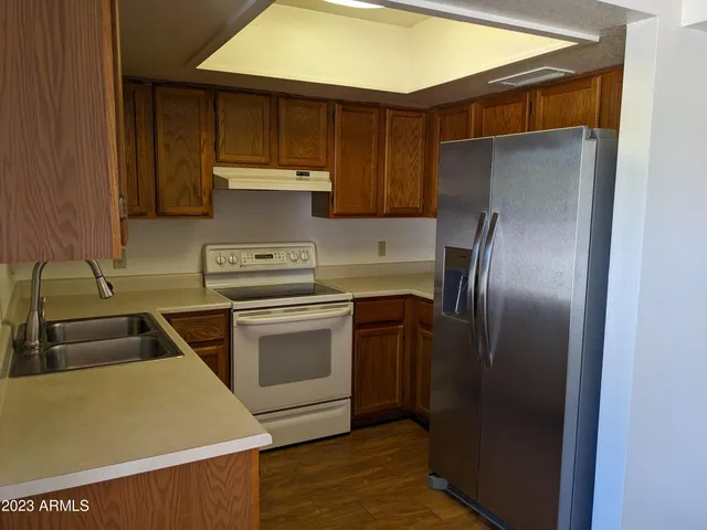 a kitchen with a refrigerator sink and stove