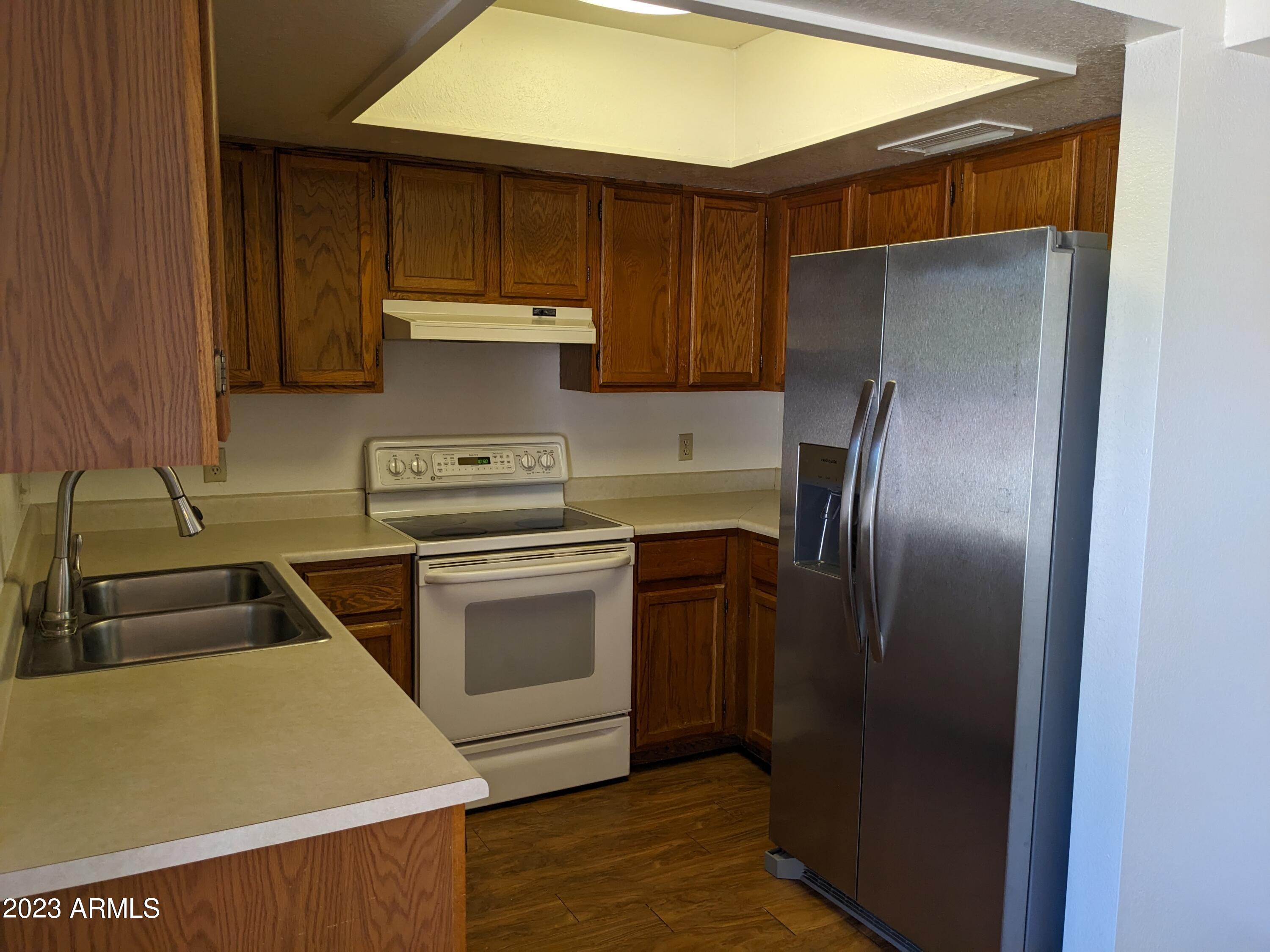 16477 East Ashbrook Drive, Unit B Fountain Hills, AZ 85268 - Photo 7 of 10 a kitchen with a refrigerator sink and stove
