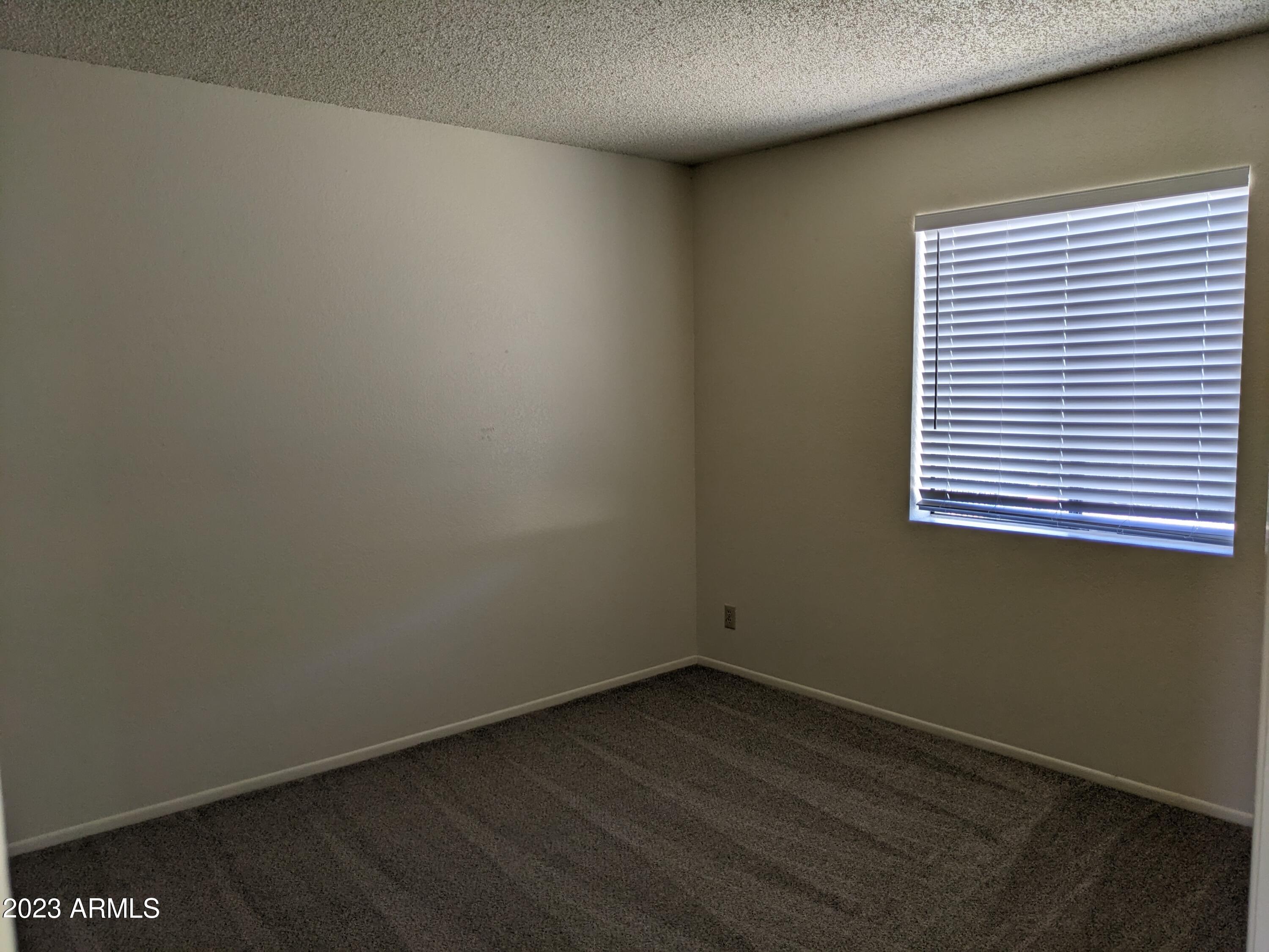 16477 East Ashbrook Drive, Unit B Fountain Hills, AZ 85268 - Photo 9 of 10 an empty room with wooden floor