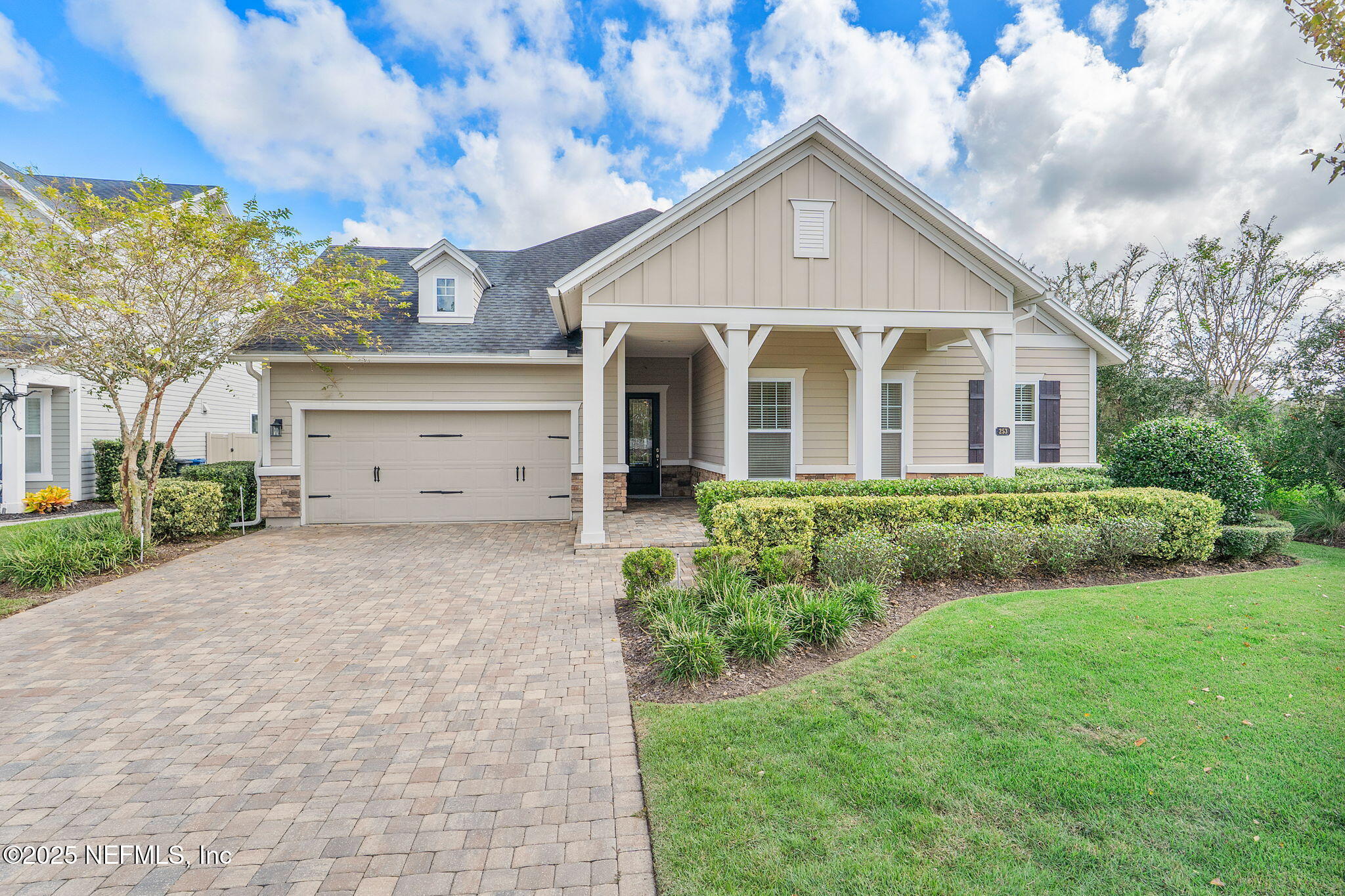 a front view of a house with a yard and garage
