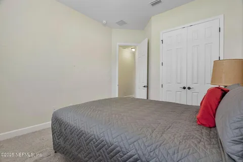 a bed room with a bed and a lamp