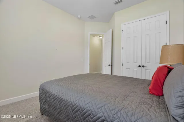 a bed room with a bed and a lamp