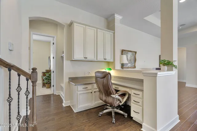 a view of a livingroom with a kitchen space and a window