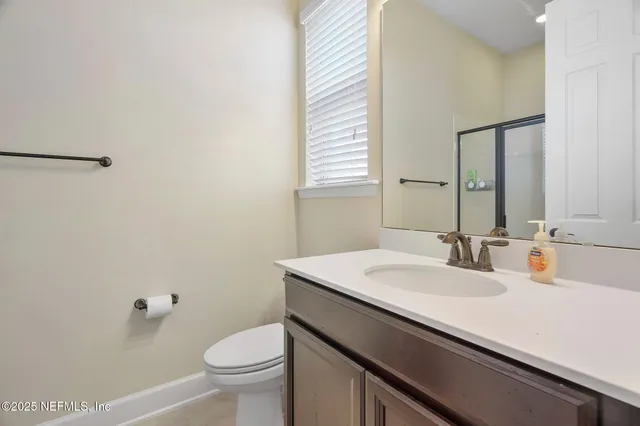 a large kitchen with kitchen island a sink a center island and stainless steel appliances