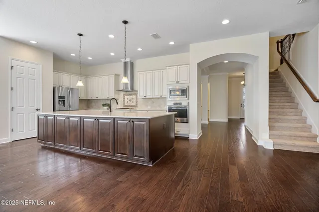 an open kitchen with a table and chairs in it