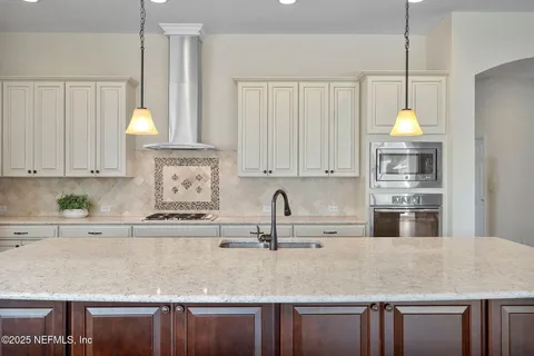a view of a livingroom with furniture and floor to ceiling window