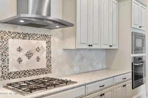 a view of a dining room with furniture a chandelier and wooden floor