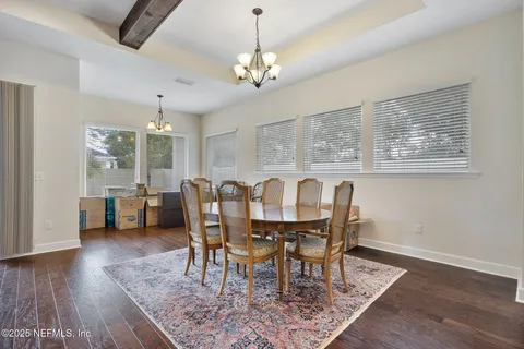 a view of a living room and kitchen with furniture and wooden floor