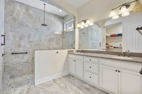front view of a house with a yard and potted plants