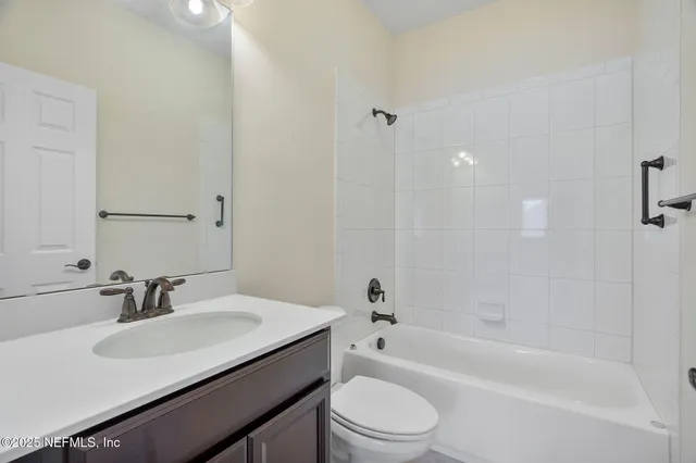 a palm tree sitting in front of a house with a big yard