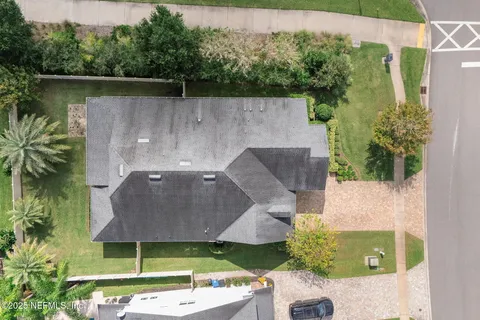 a view of a patio with a table and chairs under an umbrella