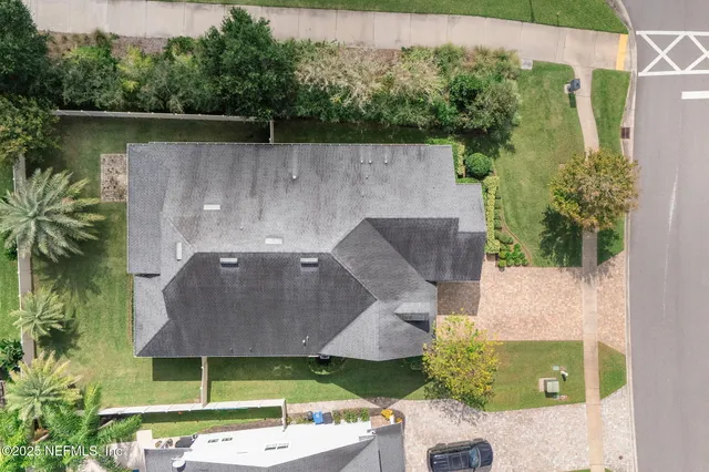 a view of a patio with a table and chairs under an umbrella