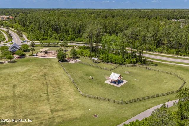 an aerial view of a house with outdoor space and lake view