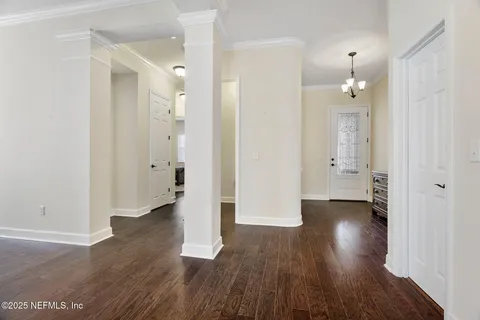 an empty room with wooden floor and a gallery