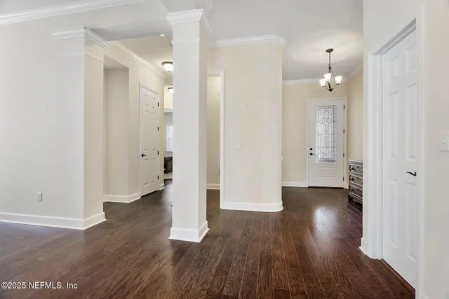 an empty room with wooden floor and a gallery
