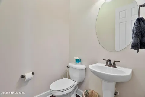 a bathroom with a sink toilet and a mirror
