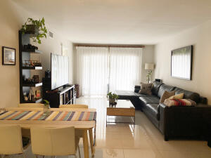 2650 Greenwood Terrace, Unit G125 Boca Raton, FL 33431 - Photo 5 of 23 a living room with furniture and large windows