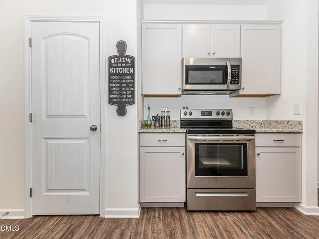 a kitchen with stainless steel appliances white cabinets and a stove