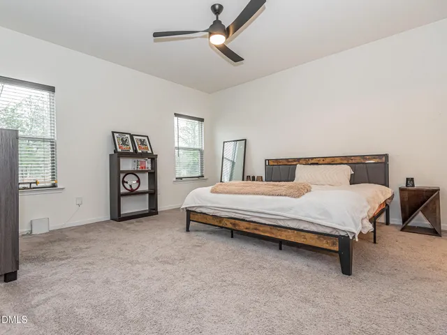 a spacious bedroom with a bed and a window