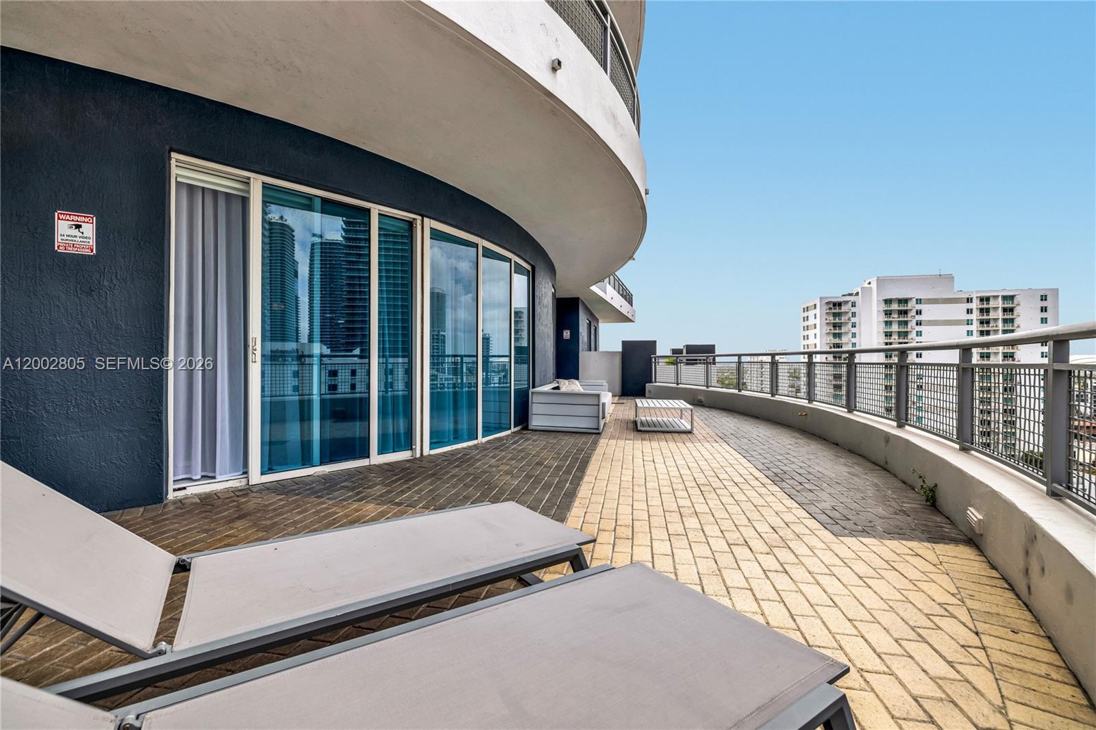 60 Southwest 13th Street, Unit 1124 Miami, FL 33130 - Photo 20 of 30 a view of balcony with floor to ceiling windows and wooden floor