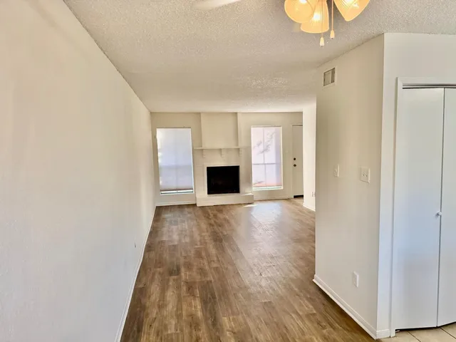 a view of a room with wooden floor and fireplace