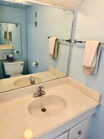 a bathroom with a sink and mirror