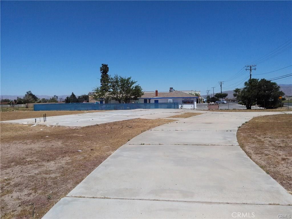 15120 Main Street Hesperia, CA 92345 - Photo 7 of 12 a view of a dry yard with a house