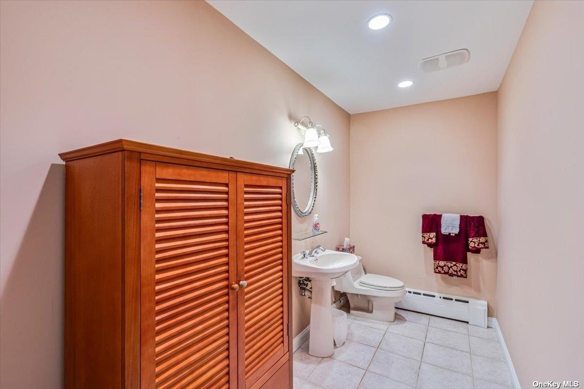 4 Midfarm Road Rockville Centre, NY 11570 - Photo 13 of 25 a bathroom with a toilet and a shower curtain