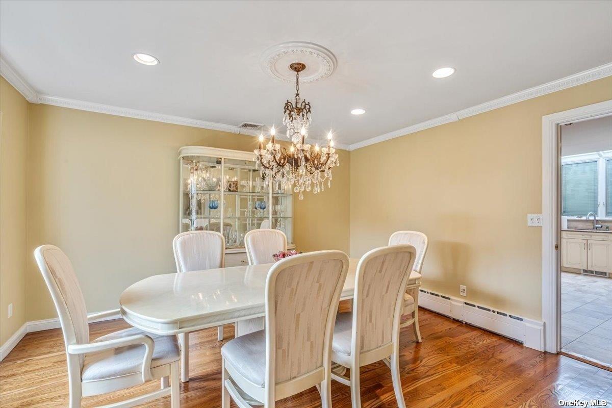 4 Midfarm Road Rockville Centre, NY 11570 - Photo 5 of 25 a view of a dining room with furniture wooden floor and chandelier