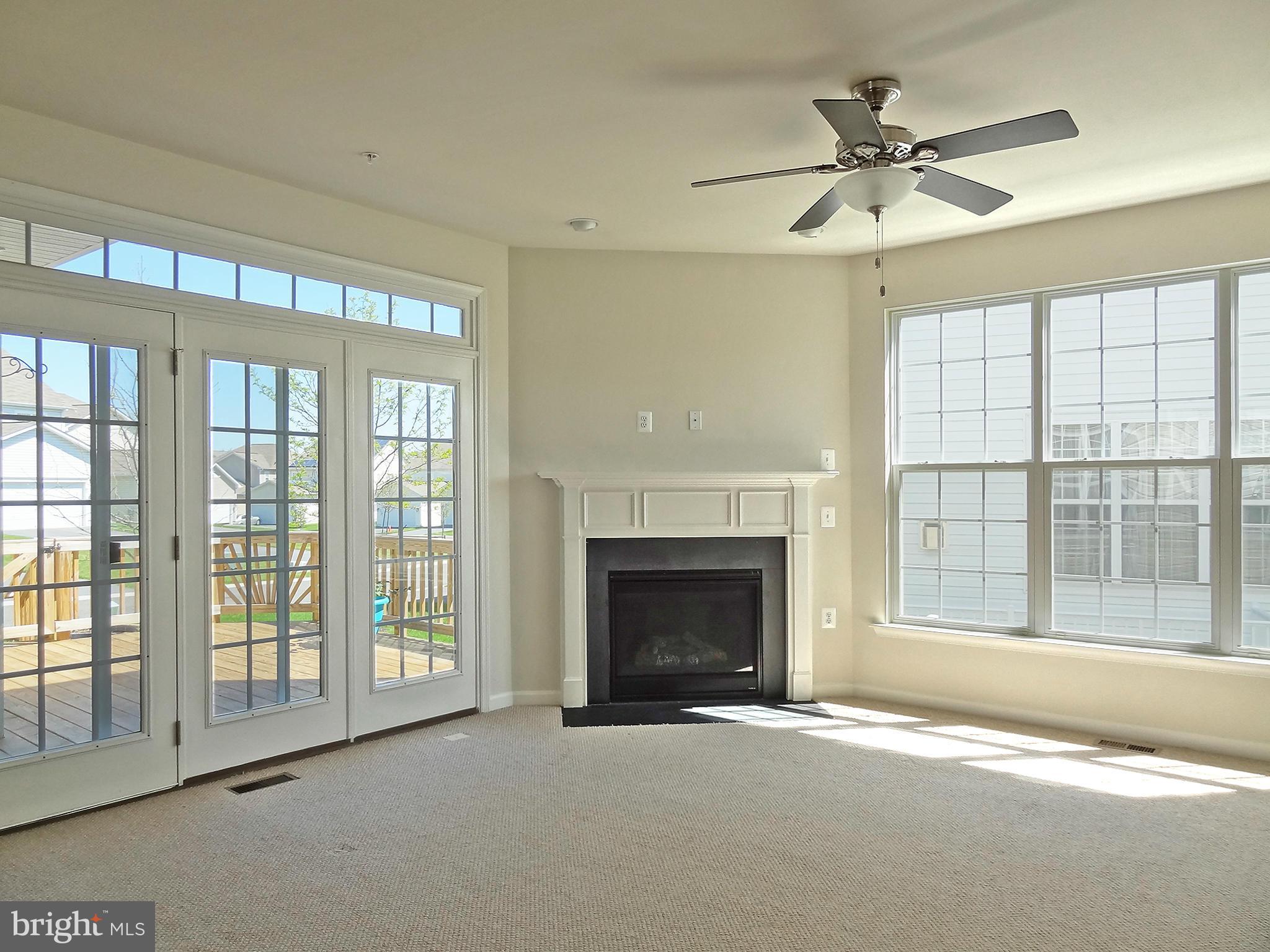 9800 Traver Street Bowie, MD 20721 - Photo 11 of 30 a view of an empty room with a fireplace and a window