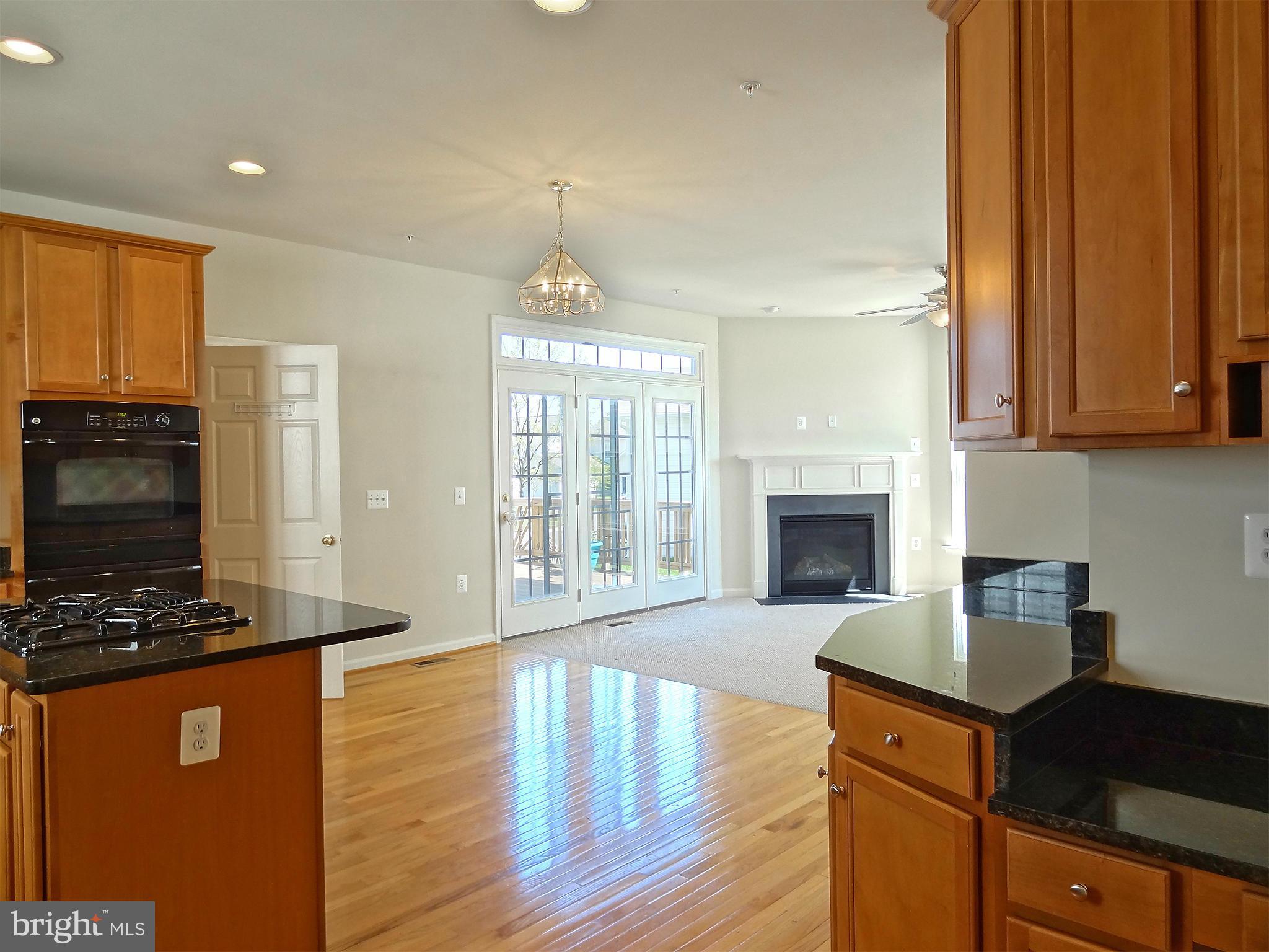 9800 Traver Street Bowie, MD 20721 - Photo 16 of 30 a kitchen with sink a refrigerator and a stove