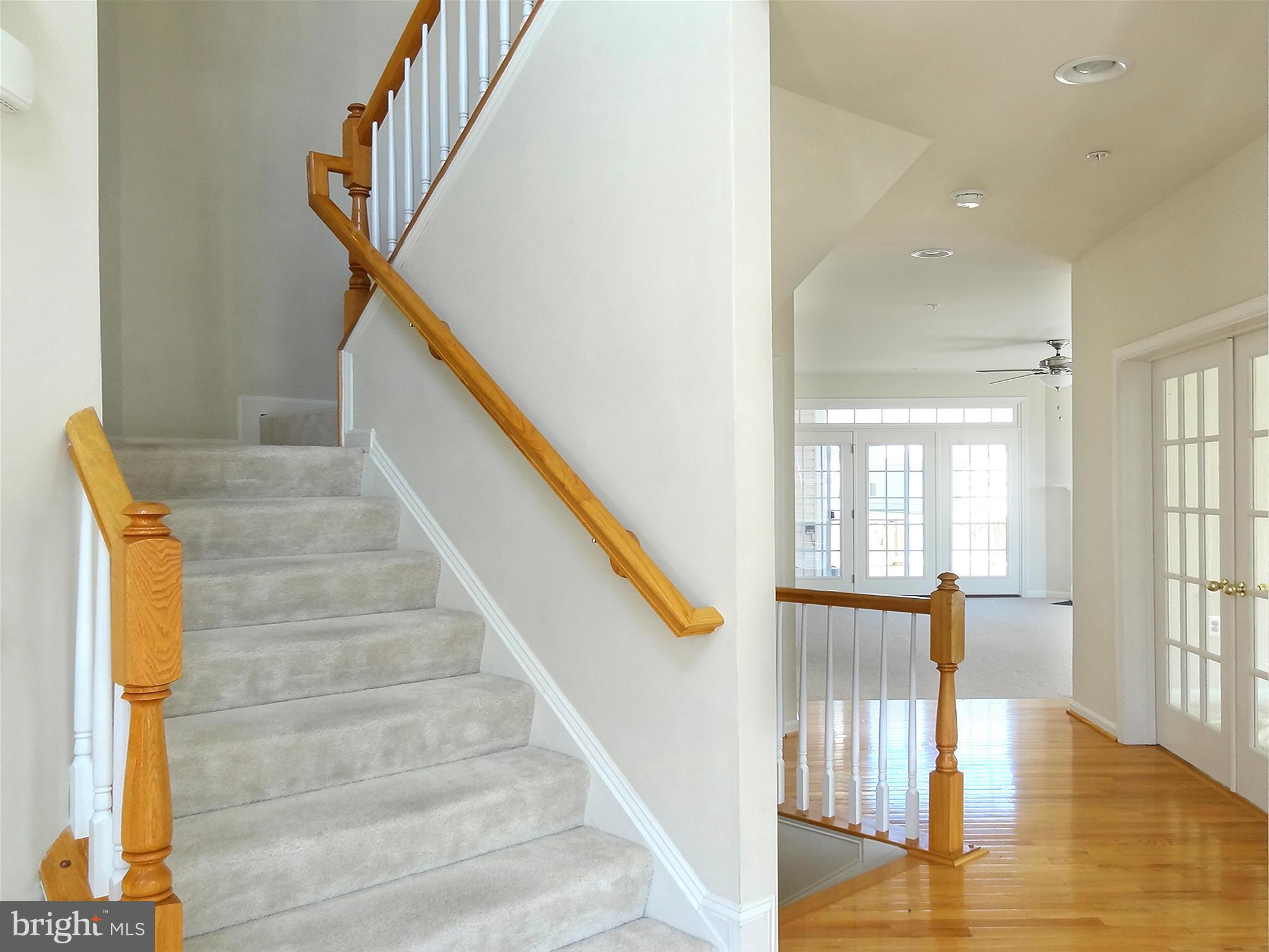 9800 Traver Street Bowie, MD 20721 - Photo 18 of 30 a view of staircase with lots of frames on wall and windows