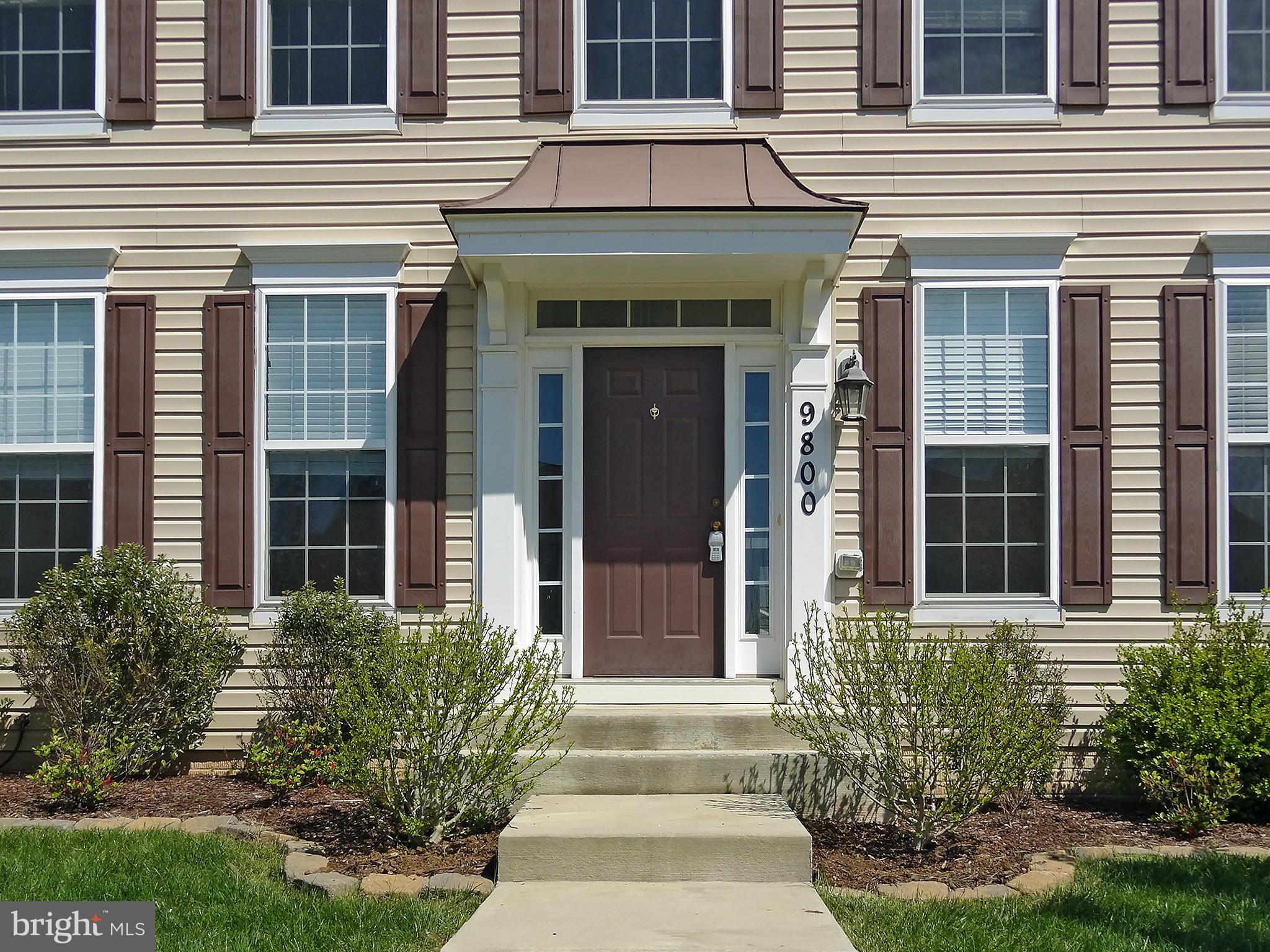 9800 Traver Street Bowie, MD 20721 - Photo 3 of 30 a front view of a house having yard and glass windows