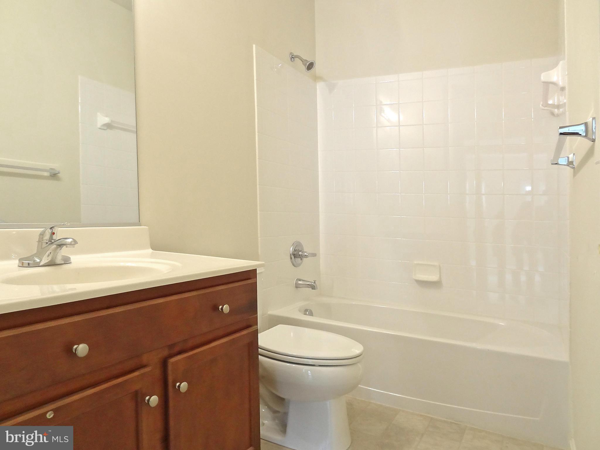 9800 Traver Street Bowie, MD 20721 - Photo 30 of 30 a bathroom with a sink a toilet and shower